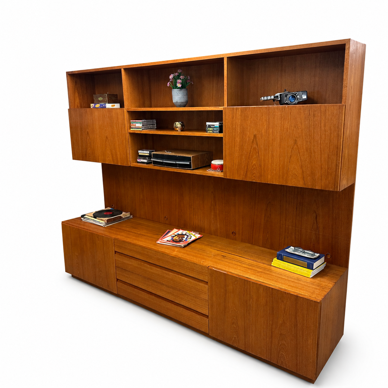 1960s Danish teak wall unit on a white background, angled view