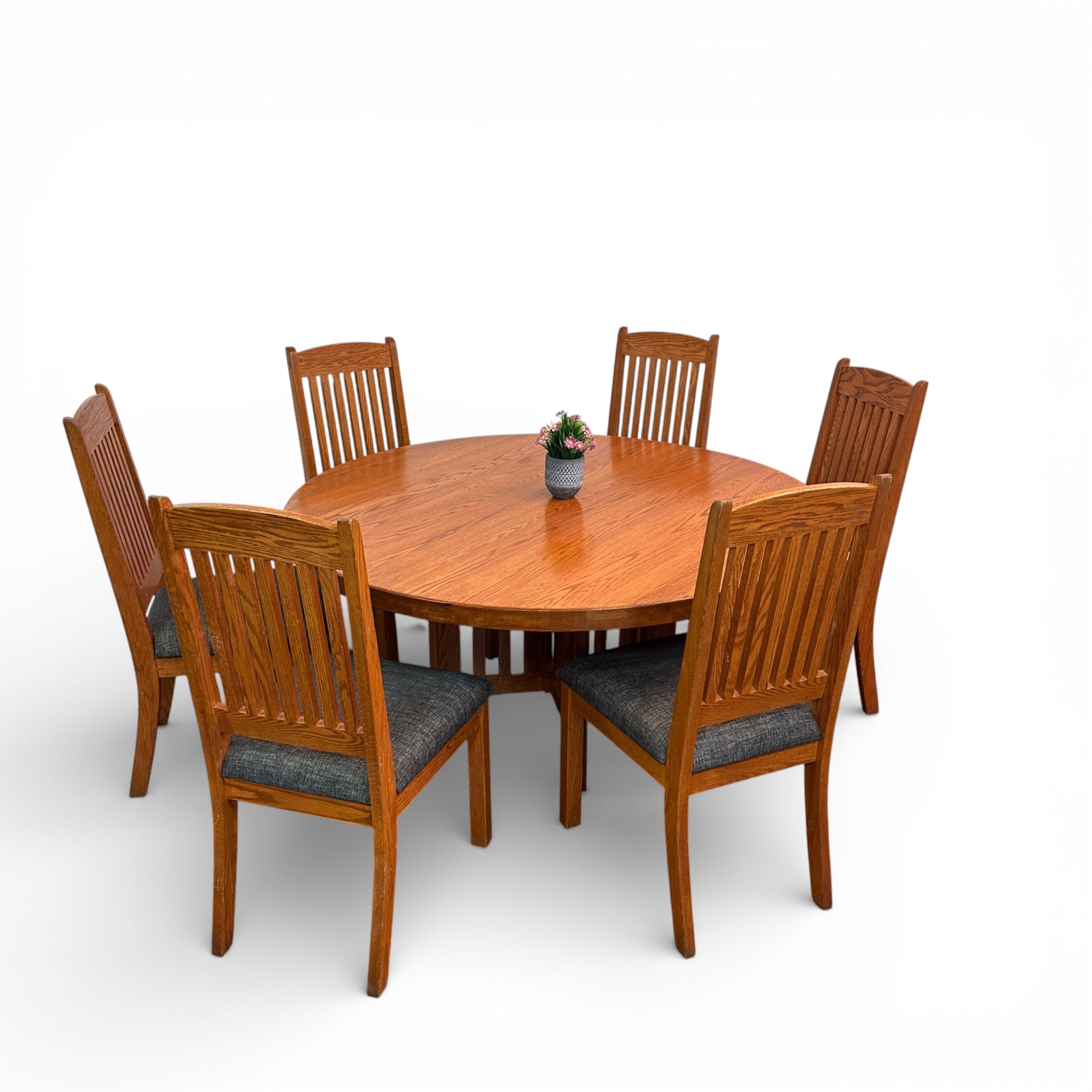Wooden dining table with six matching chairs on a white background