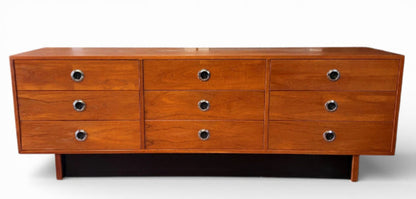 Wooden dresser with multiple drawers on a white background