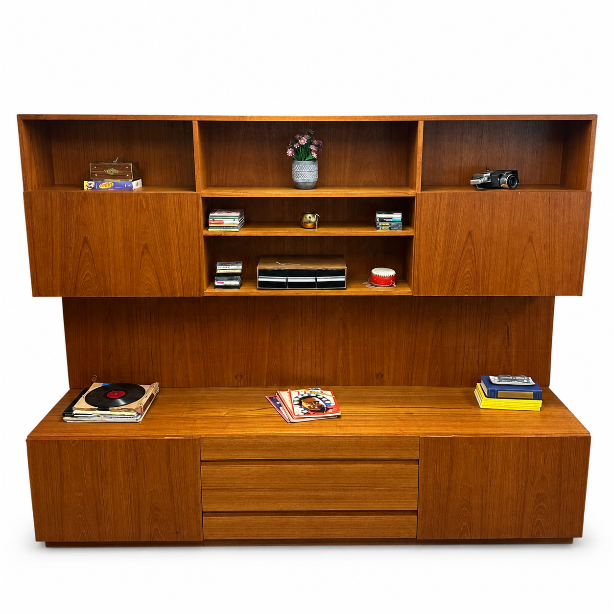 1960s Danish teak wall unit on a white background, straight-on view