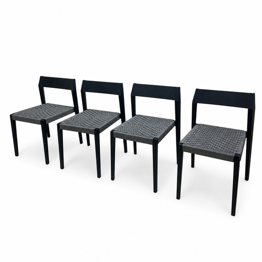 Set of four mid-century modern grey dining chairs on white background